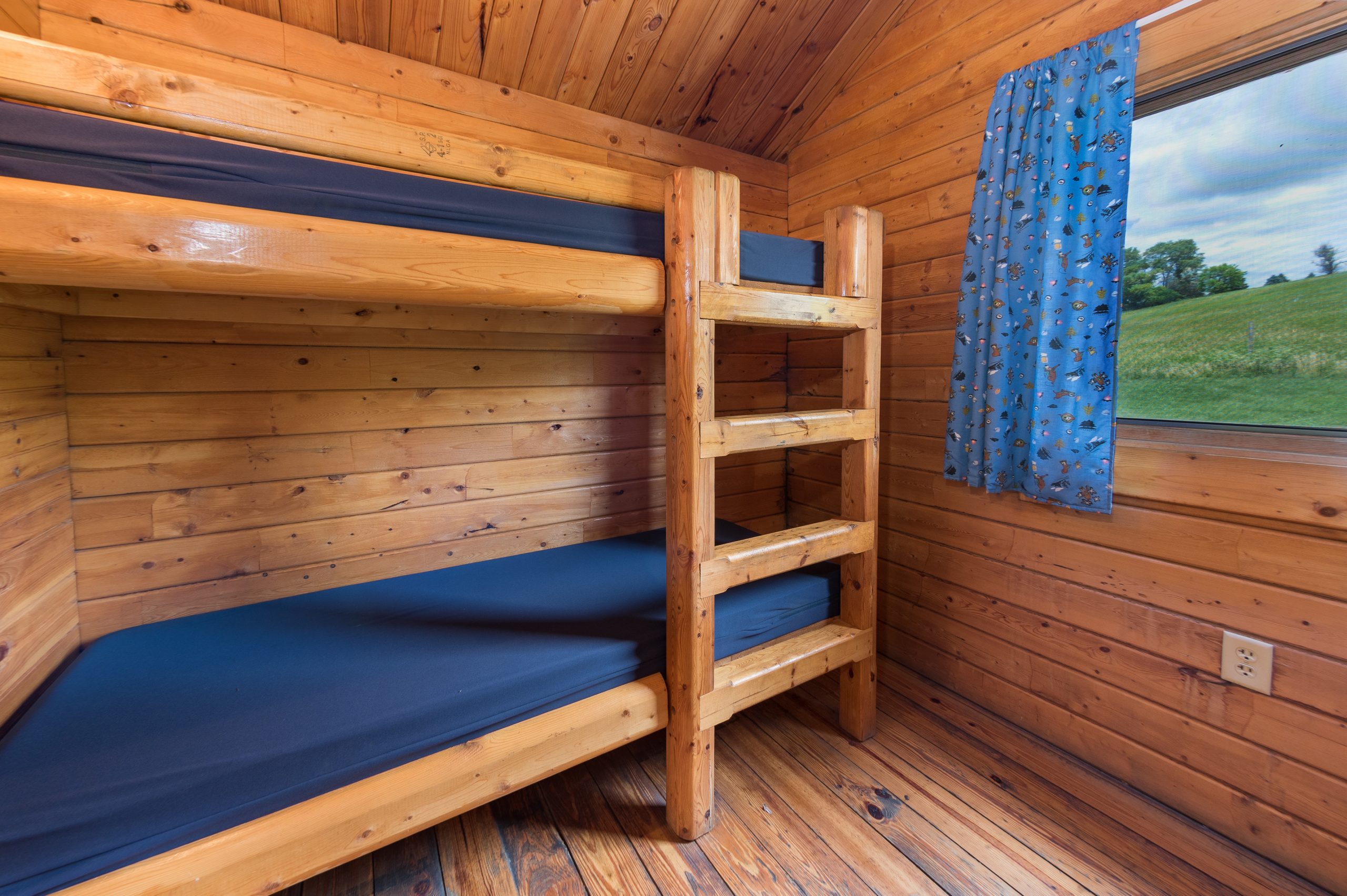 one set of single bunks in bungalow cabin. Window out the back