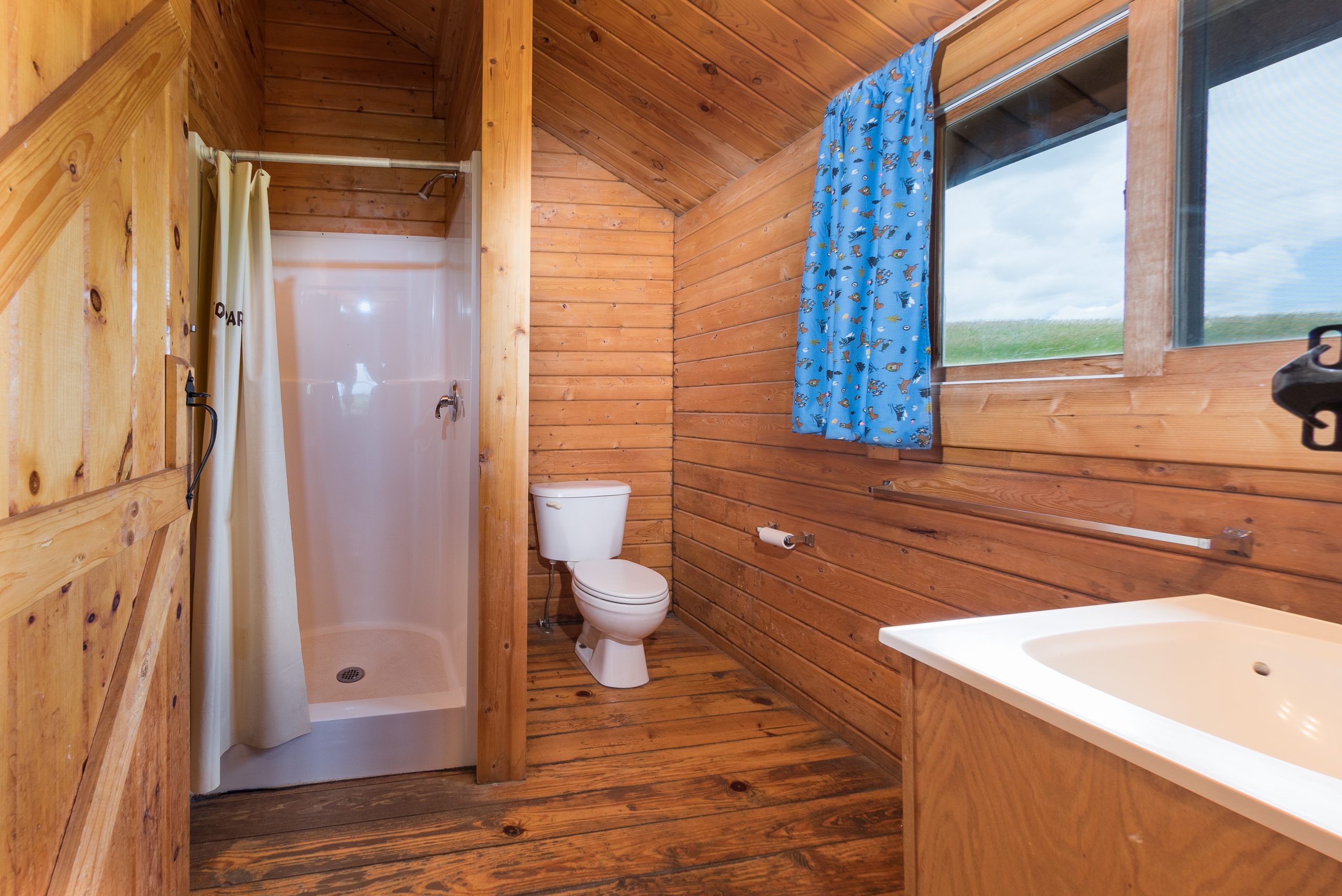 Bungalow Bathroom. Standard sized shower, toilet and sink