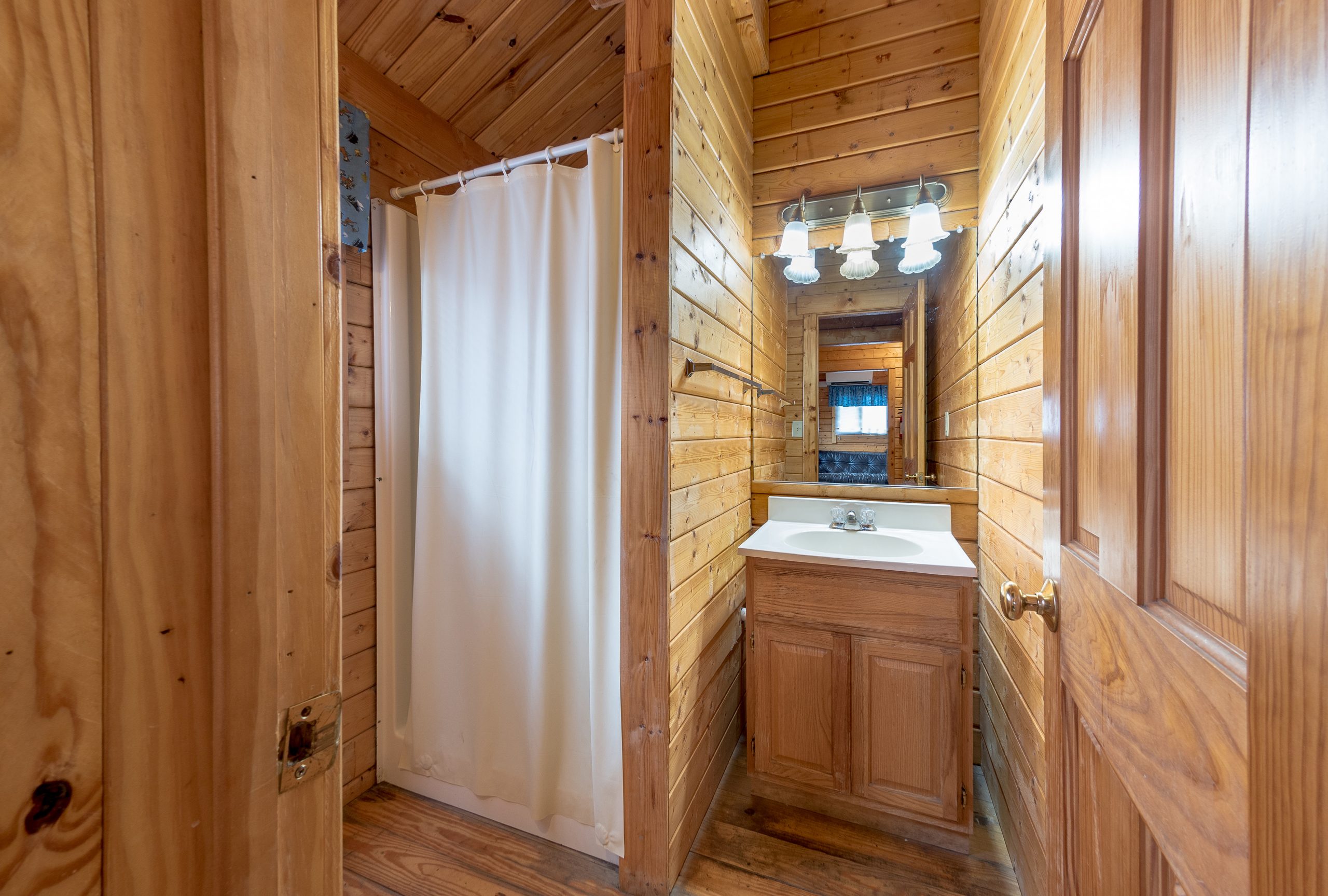 Cottage bathroom from the hall. Sink and shower pictured