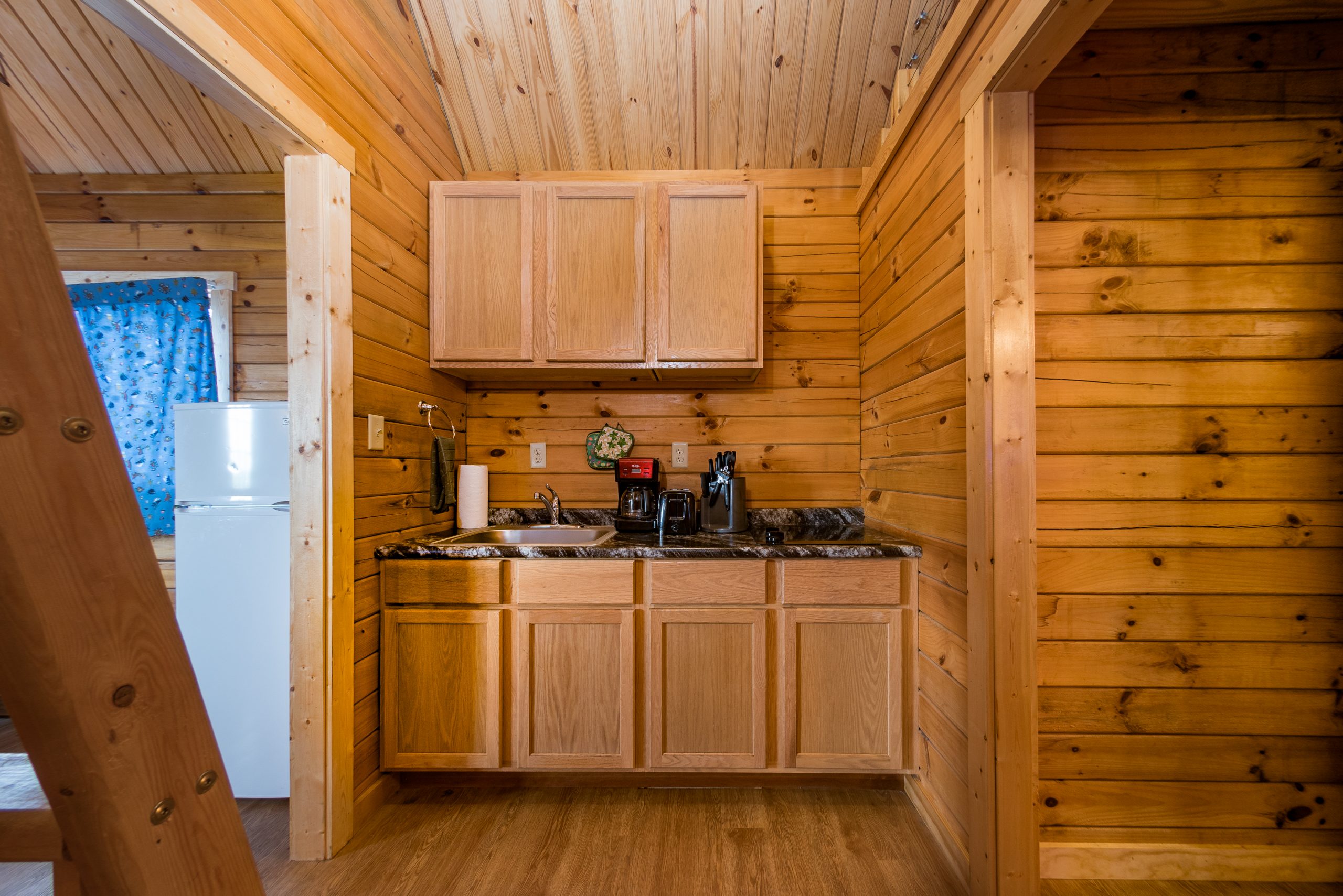 kitchenette in retreat, two burner range, sink, kitchen utensils, ladder to loft